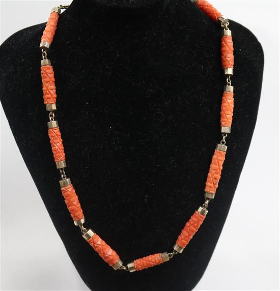 A yellow metal and carved coral baton link necklace, 44cm.